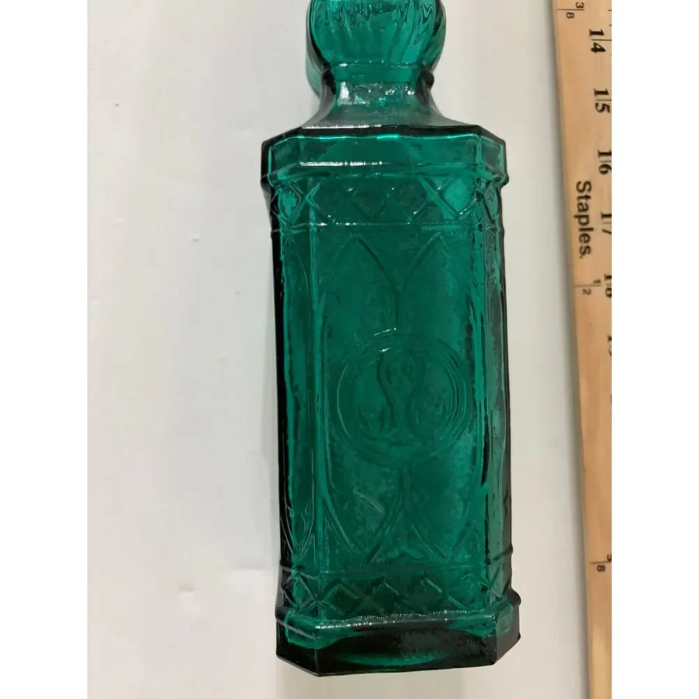 vtg emerald green glass decanter bottle with embossed sides and cork stopper